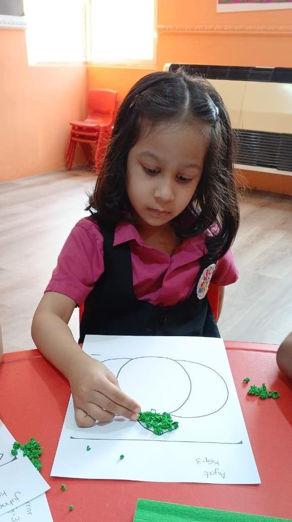 Child doing nature-printing art in a Smart Minds classroom